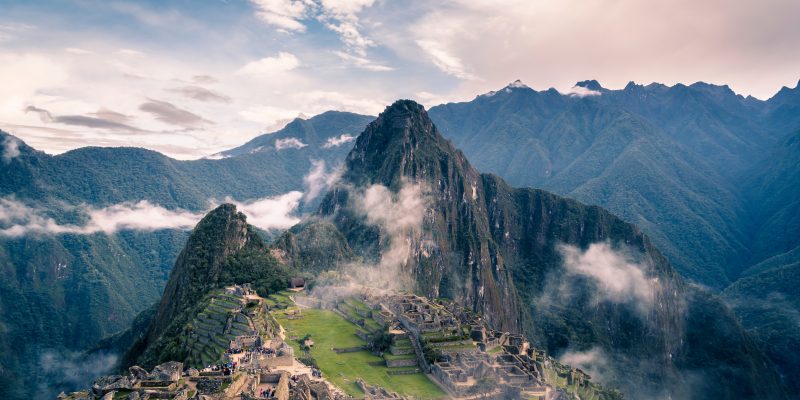 a mountain in Peru with clouds all around it
