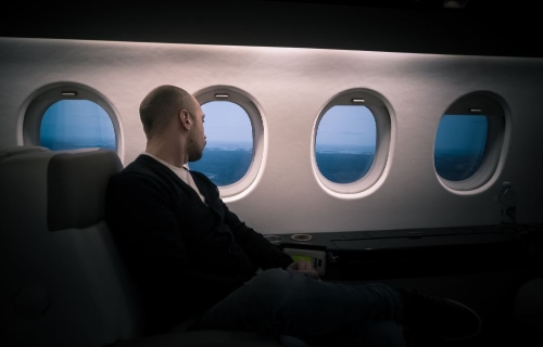 a man sitting in the first class area on a plane